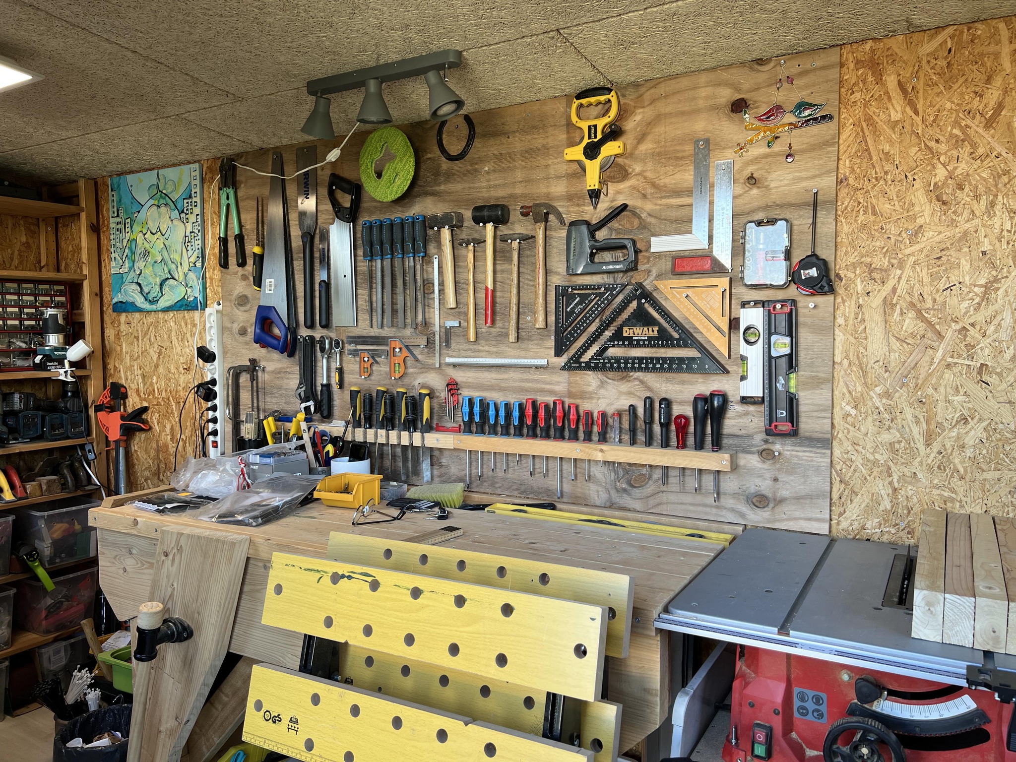 Odinn's toolshed with a woodworking bench and an organized wall of hand tools.